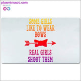 Plus Minus Co Some girls like to wear bows real girls shoot them Desk Mats, view 2